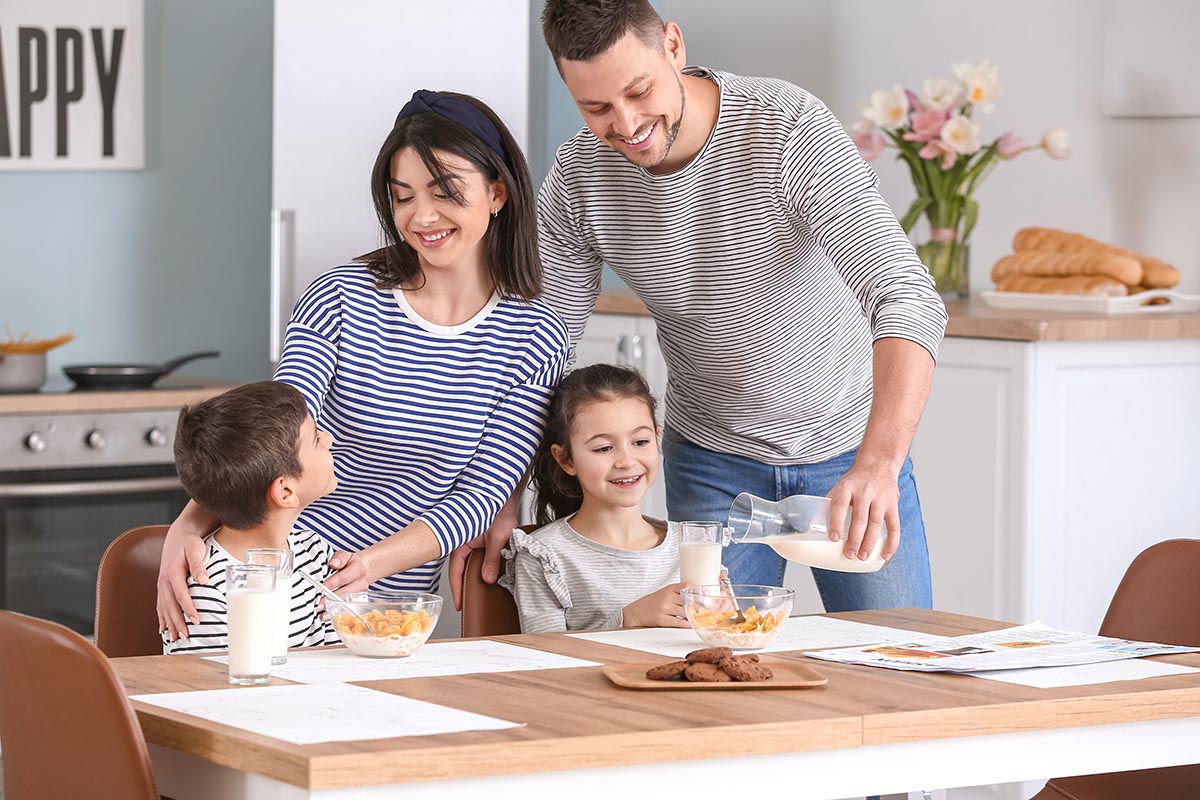 Family drinking milk during breakfast at home